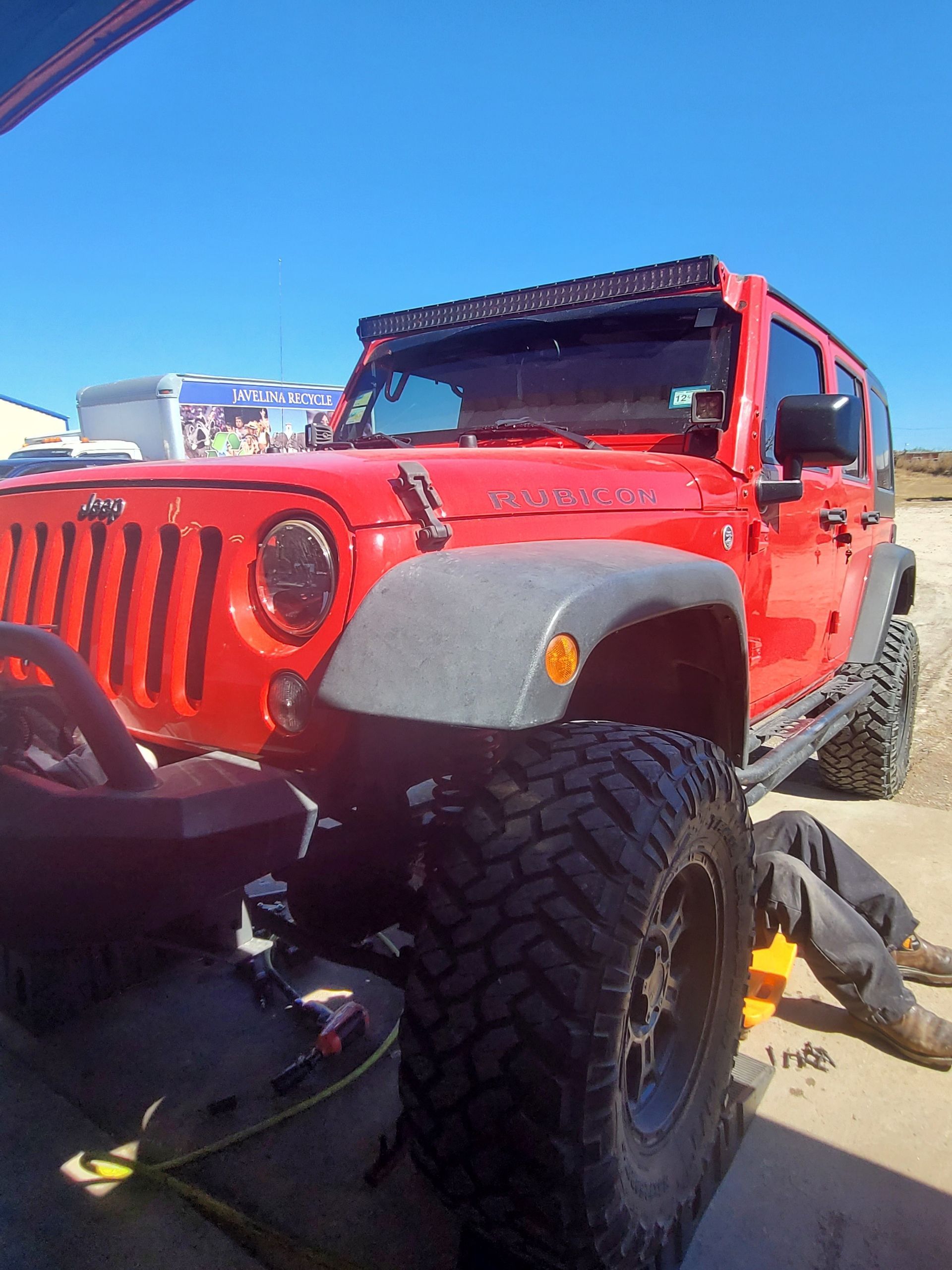 1 of our technicians, Jason, working on the suspension of this Jeep Wrangler