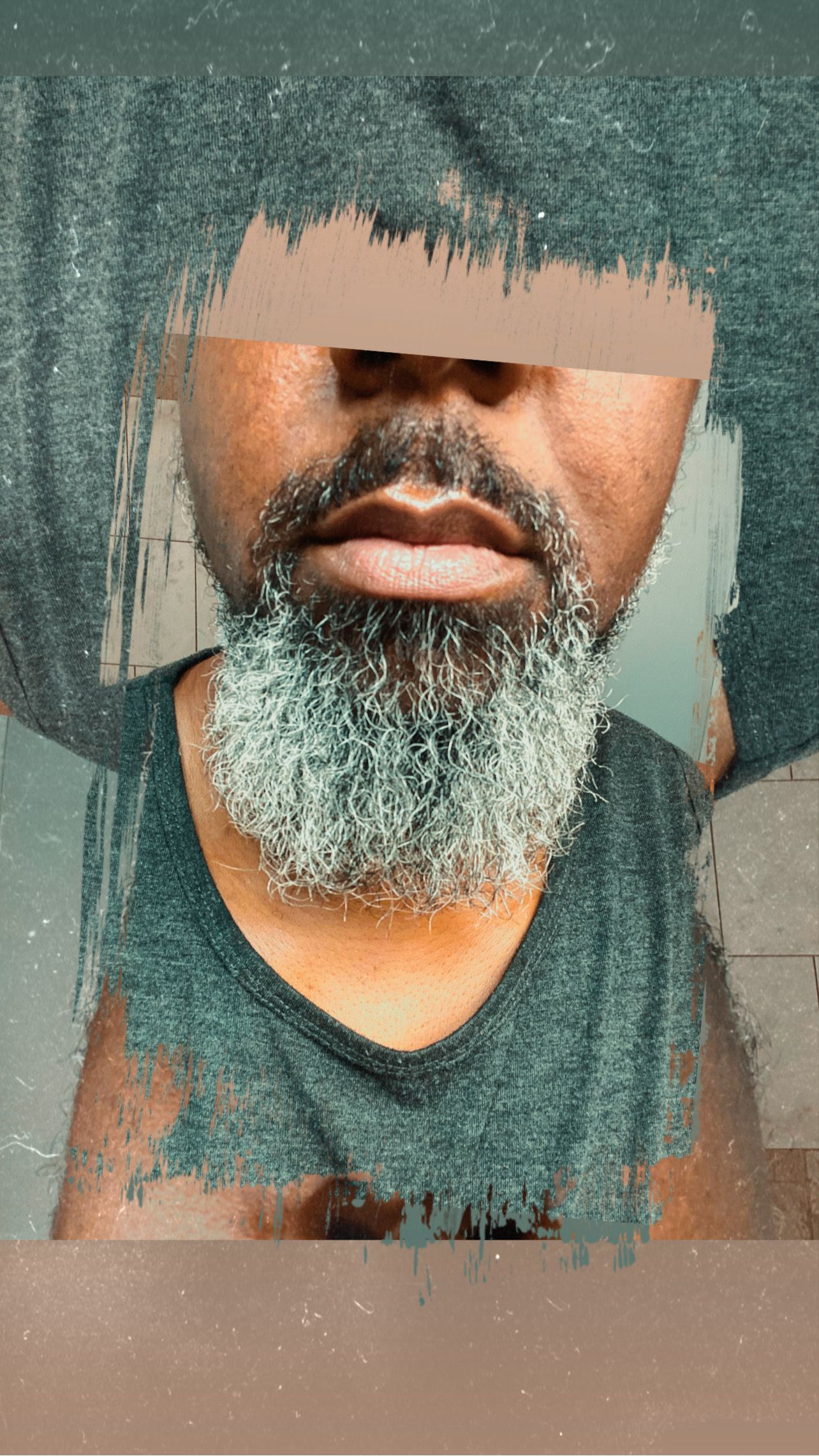 Man with gray beard and obscured eyes, wearing a tank top, face partially covered in a textured filter.