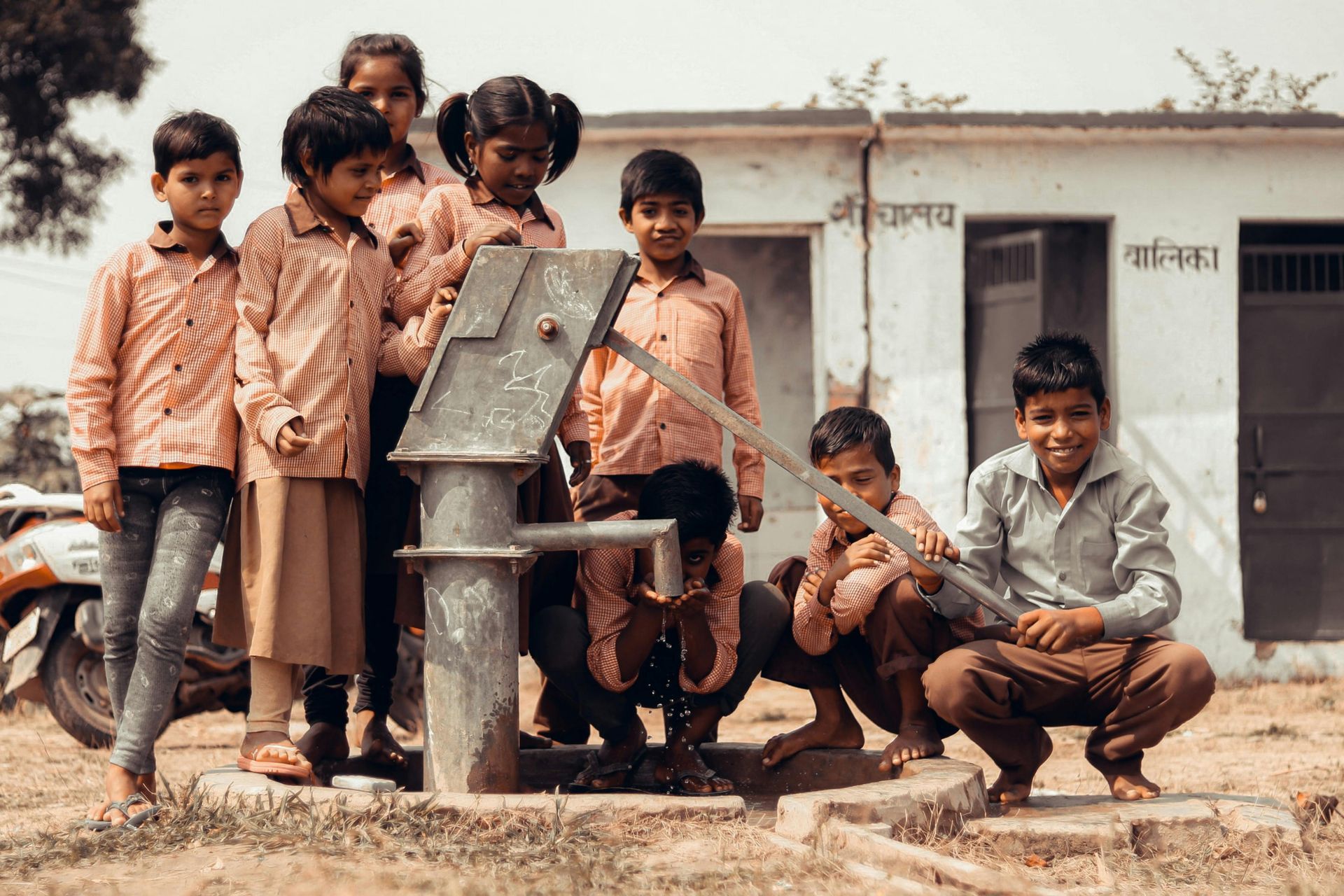 children in India surrounding a water well