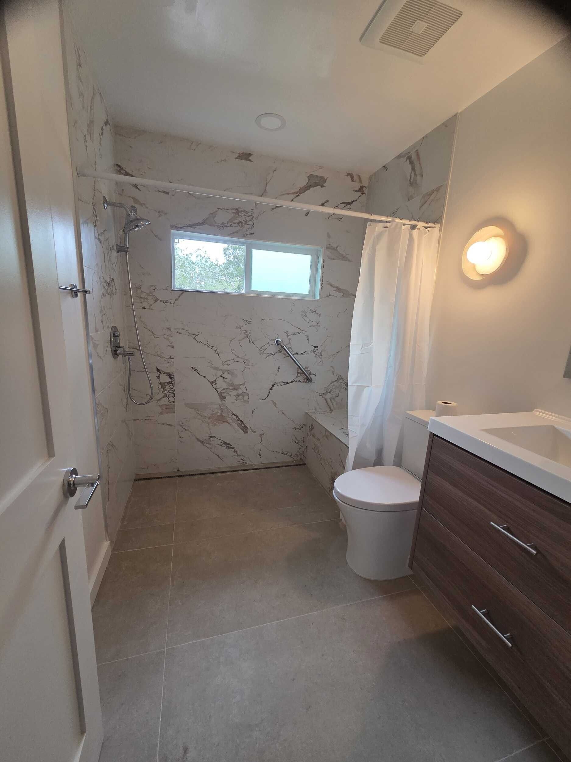 Dream Build Services recently completed an accessible bathroom renovation in the Bay Area, transforming an outdated and narrow layout into a modern, mobility-friendly space. The remodel features a spacious walk-in shower with grab bars, a built-in bench, modern lighting, and sleek tile design. Ideal for aging-in-place, senior accessibility, and improved home safety.