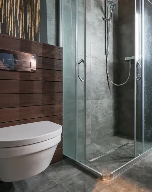A bathroom with a toilet and a shower stall.