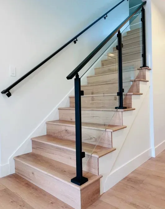 A staircase with wooden steps and a black railing