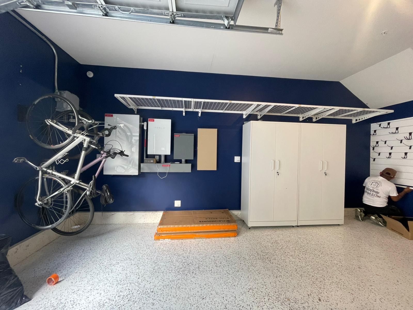 A bicycle is hanging from the ceiling of a garage.