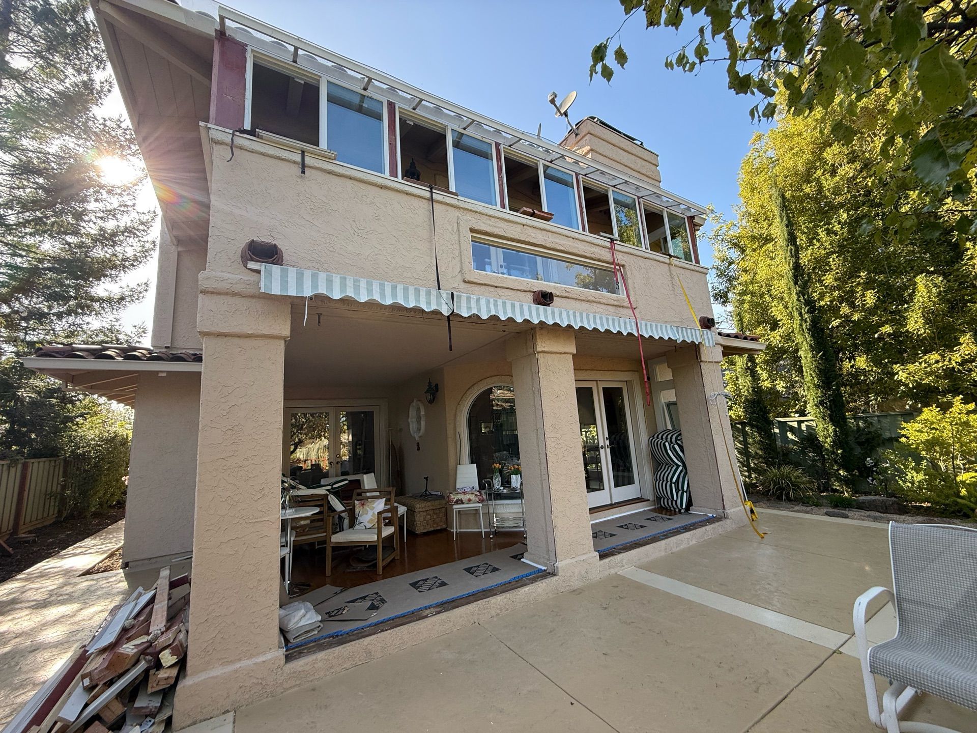 A large house with a lot of windows and a patio