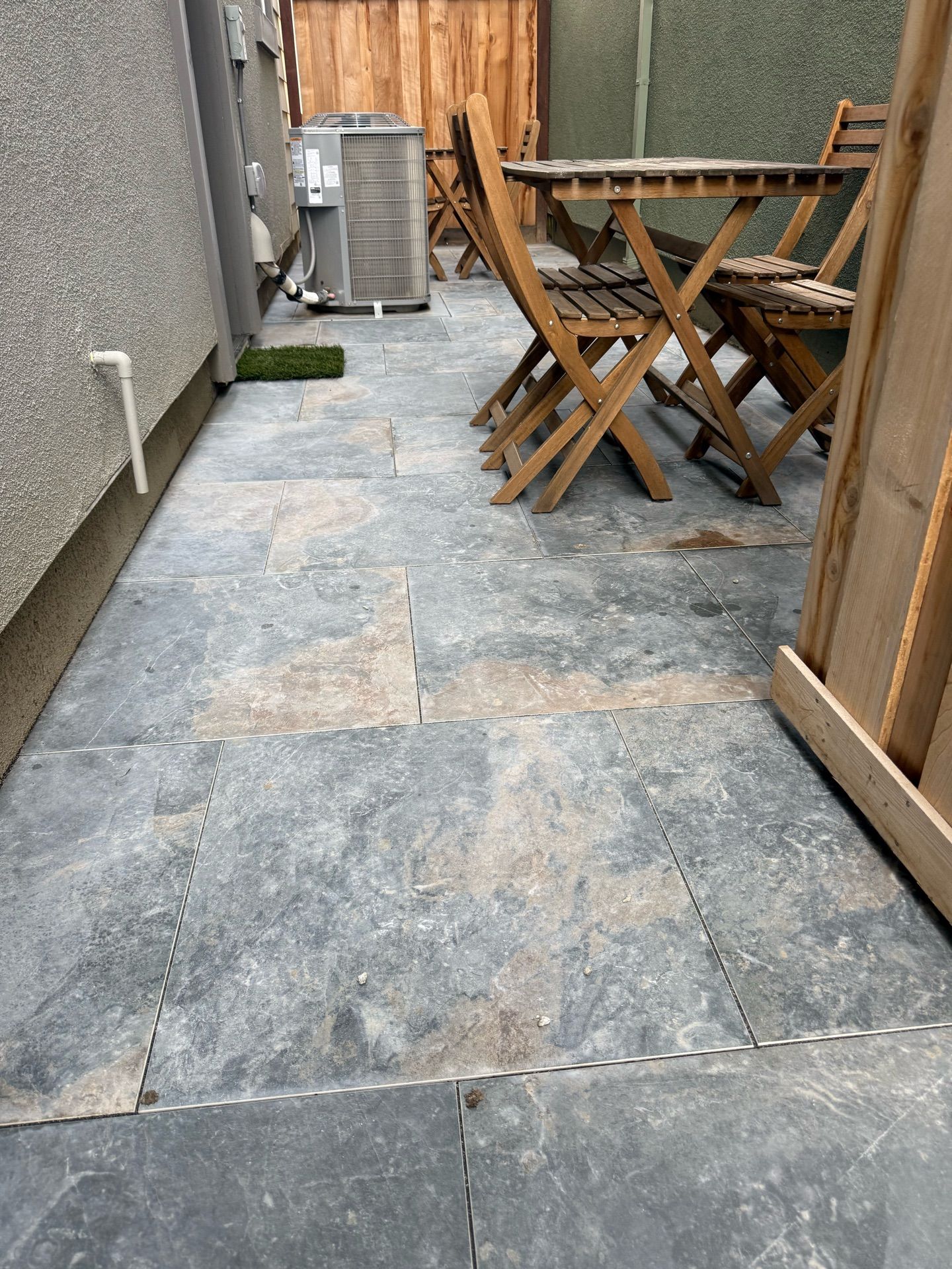 A patio with a table and chairs on it