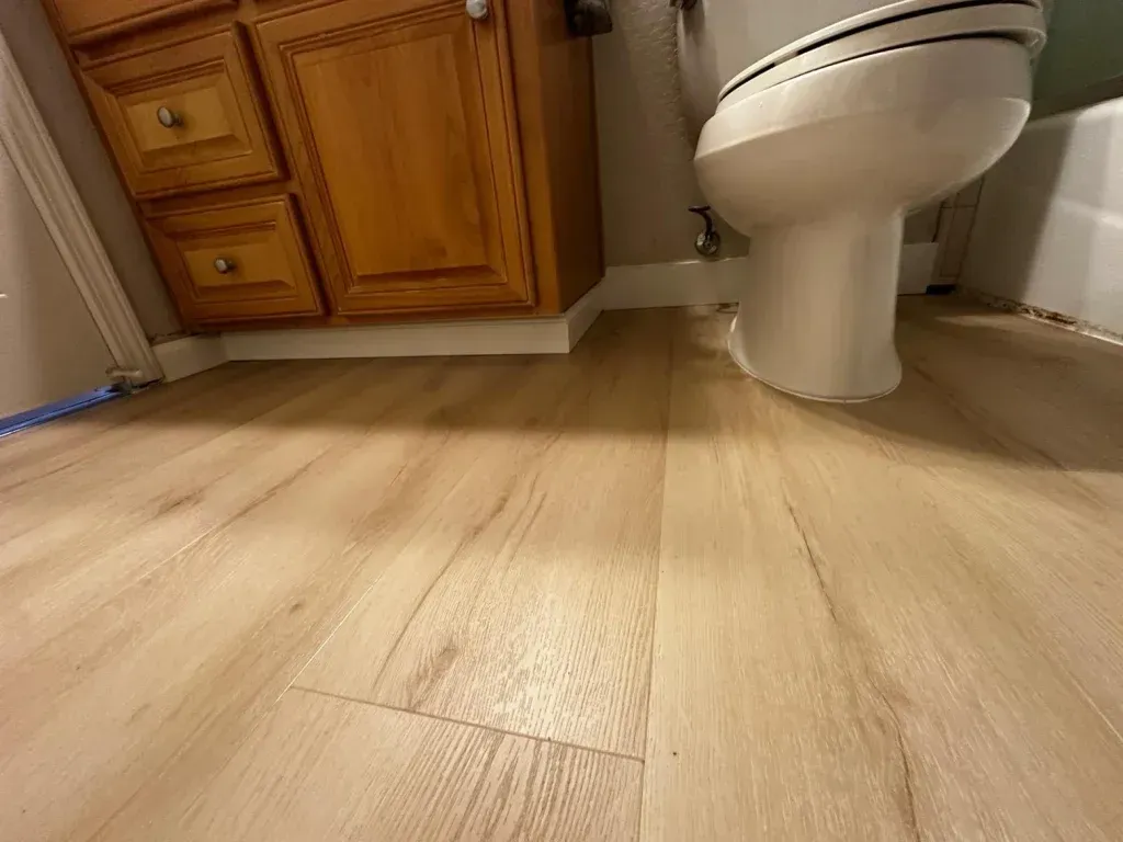 A bathroom with a toilet , sink , and bathtub.