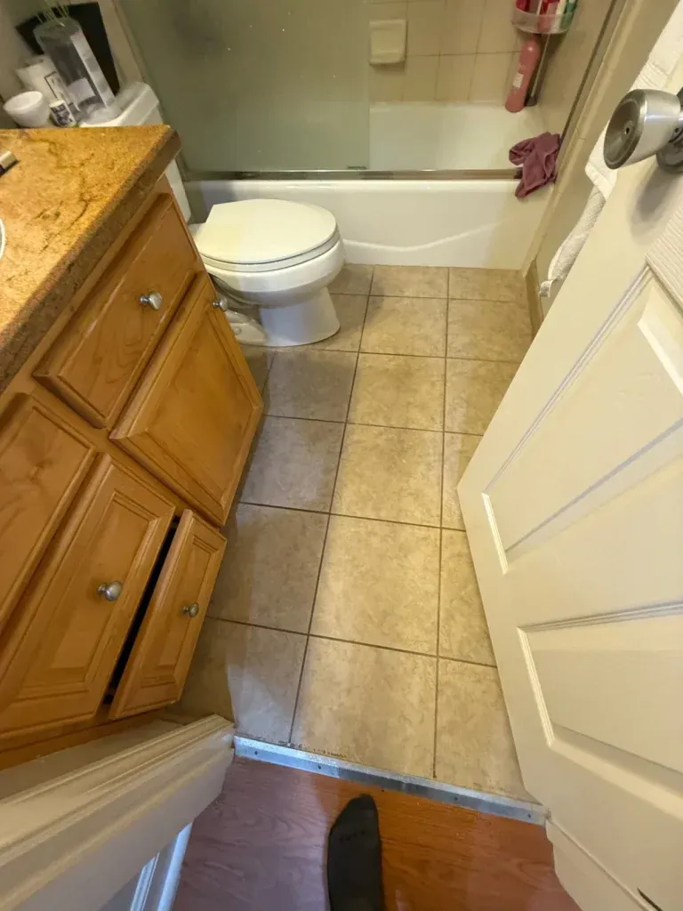 A bathroom with a toilet , sink , and bathtub.