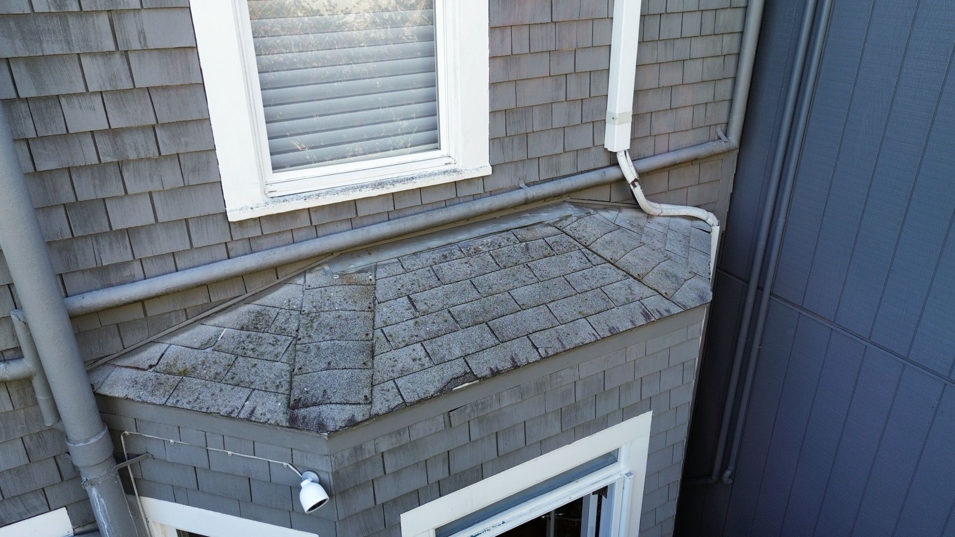 An aerial view of a house with a window and gutters