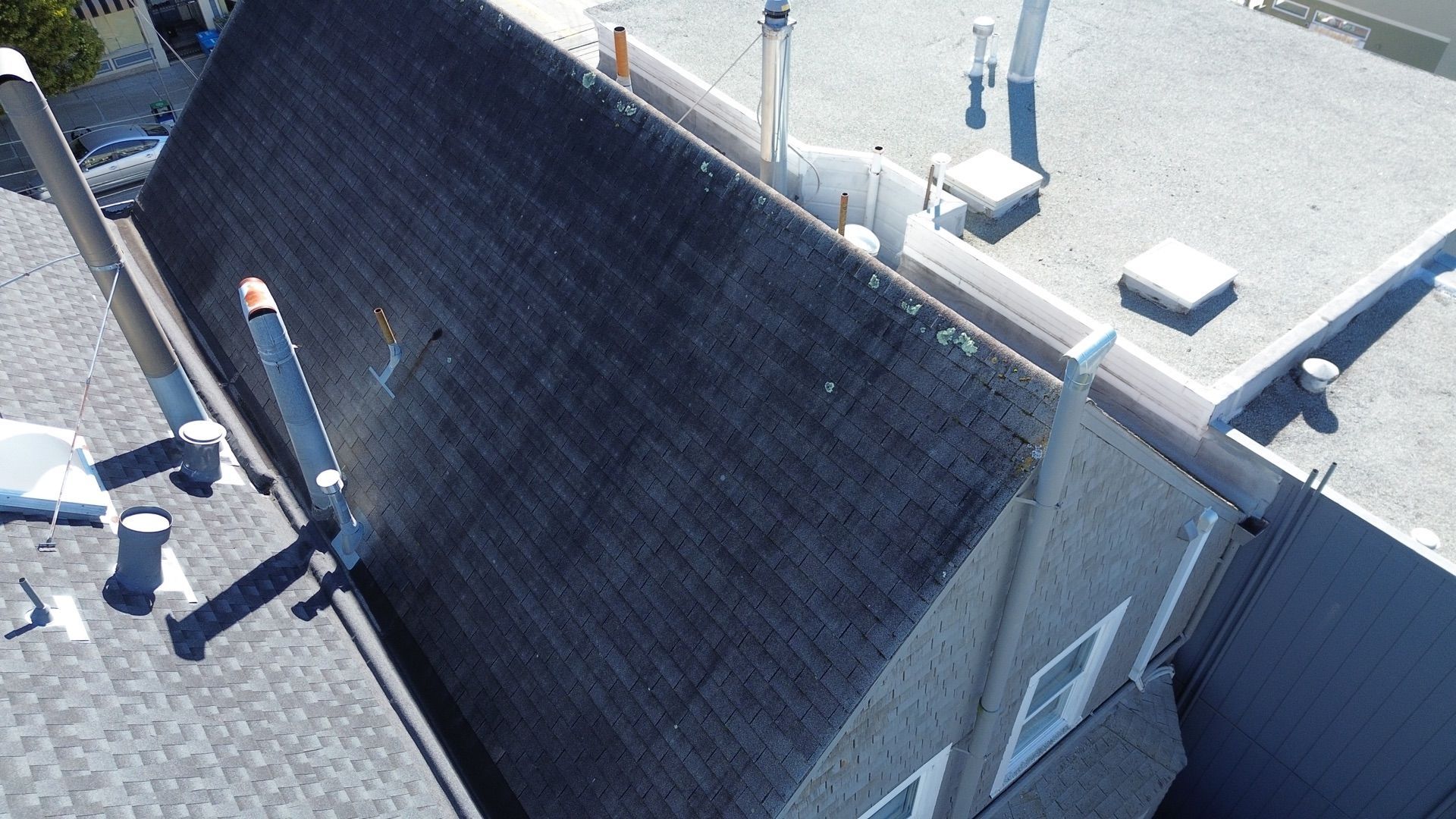 An aerial view of a roof of a building with a chimney on it.