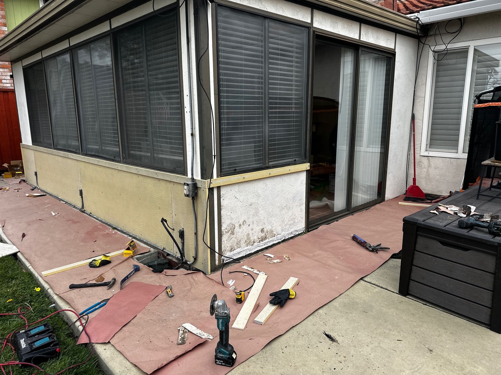 A house with a screened in porch is being remodeled.