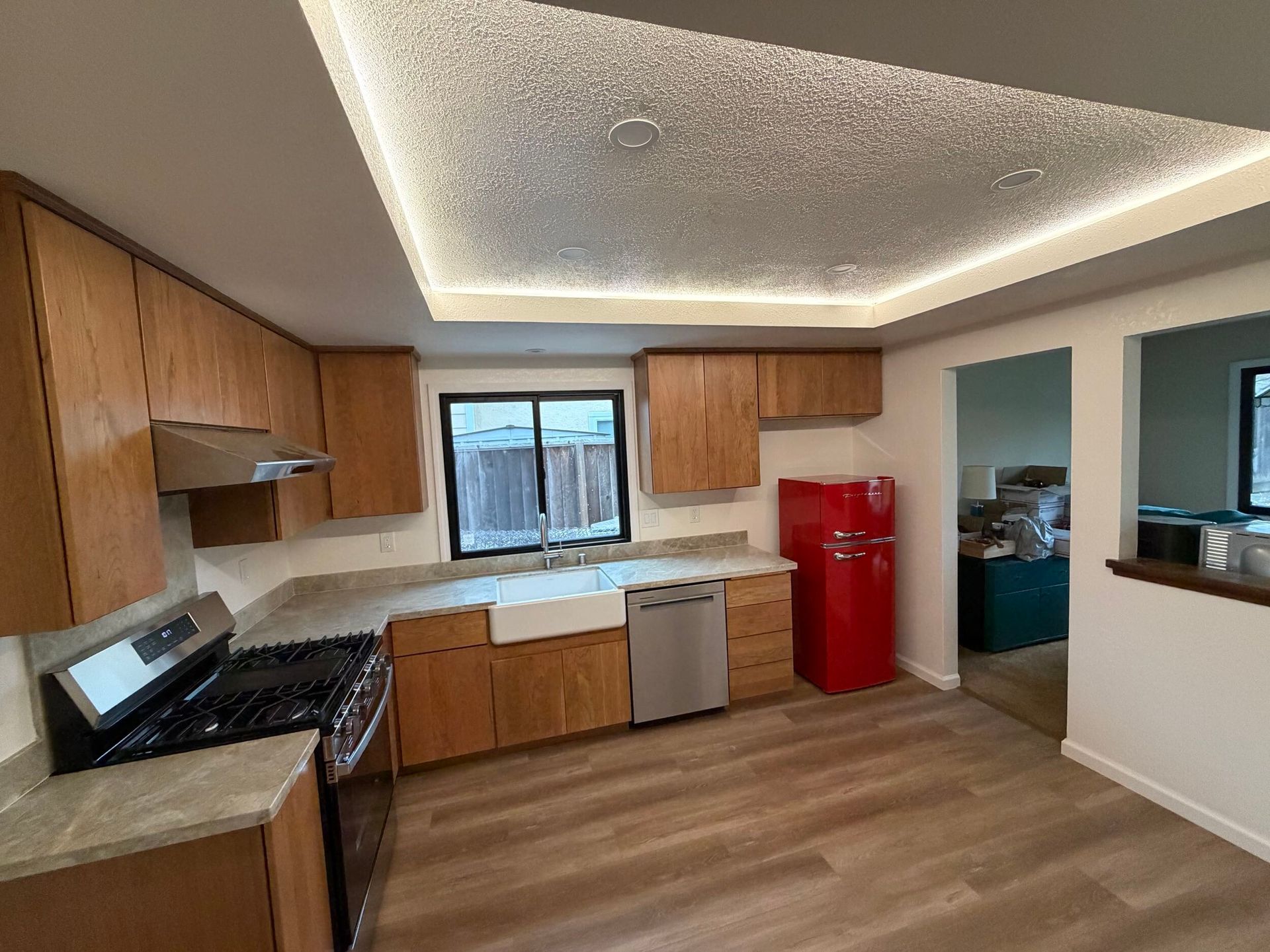 Modern kitchen remodel featuring new wood cabinetry, updated countertops, farmhouse sink, stainless steel appliances, and improved lighting. Full kitchen renovation showcasing before and after transformation, optimized layout, durable flooring, and contemporary finishes designed for functionality, comfort, and style in a residential home renovation project.