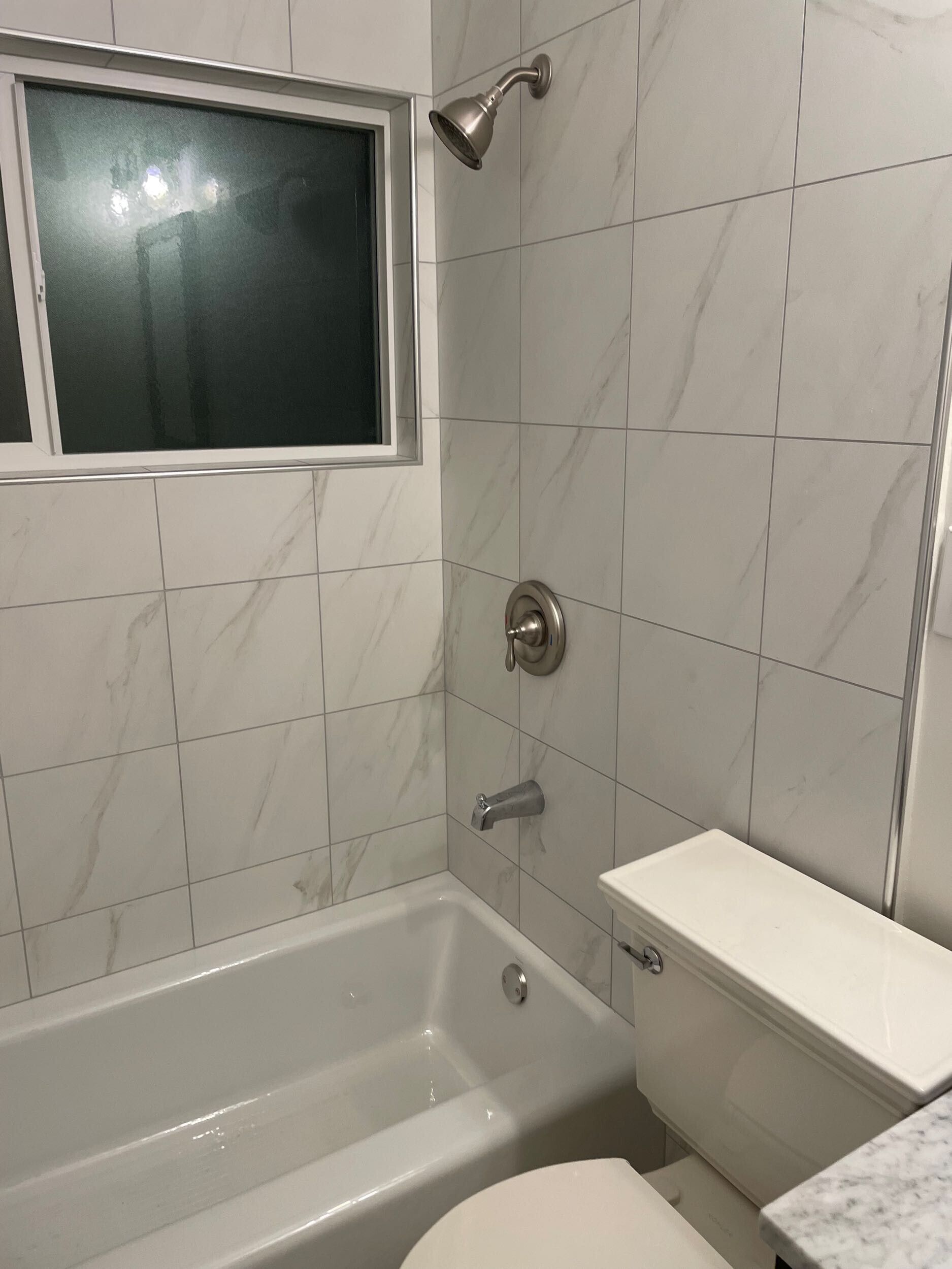 This bathroom remodel by Dream Build Services showcases a complete transformation from an outdated design to a modern, elegant space. The renovation included new marble-look wall and floor tiles, a sleek vanity with upgraded hardware, energy-efficient lighting, and modern plumbing fixtures. The result is a brighter, cleaner, and more functional bathroom that blends comfort and contemporary style. Located in the Bay Area, Dream Build Services specializes in bathroom remodels, home renovations, and functional design improvements.