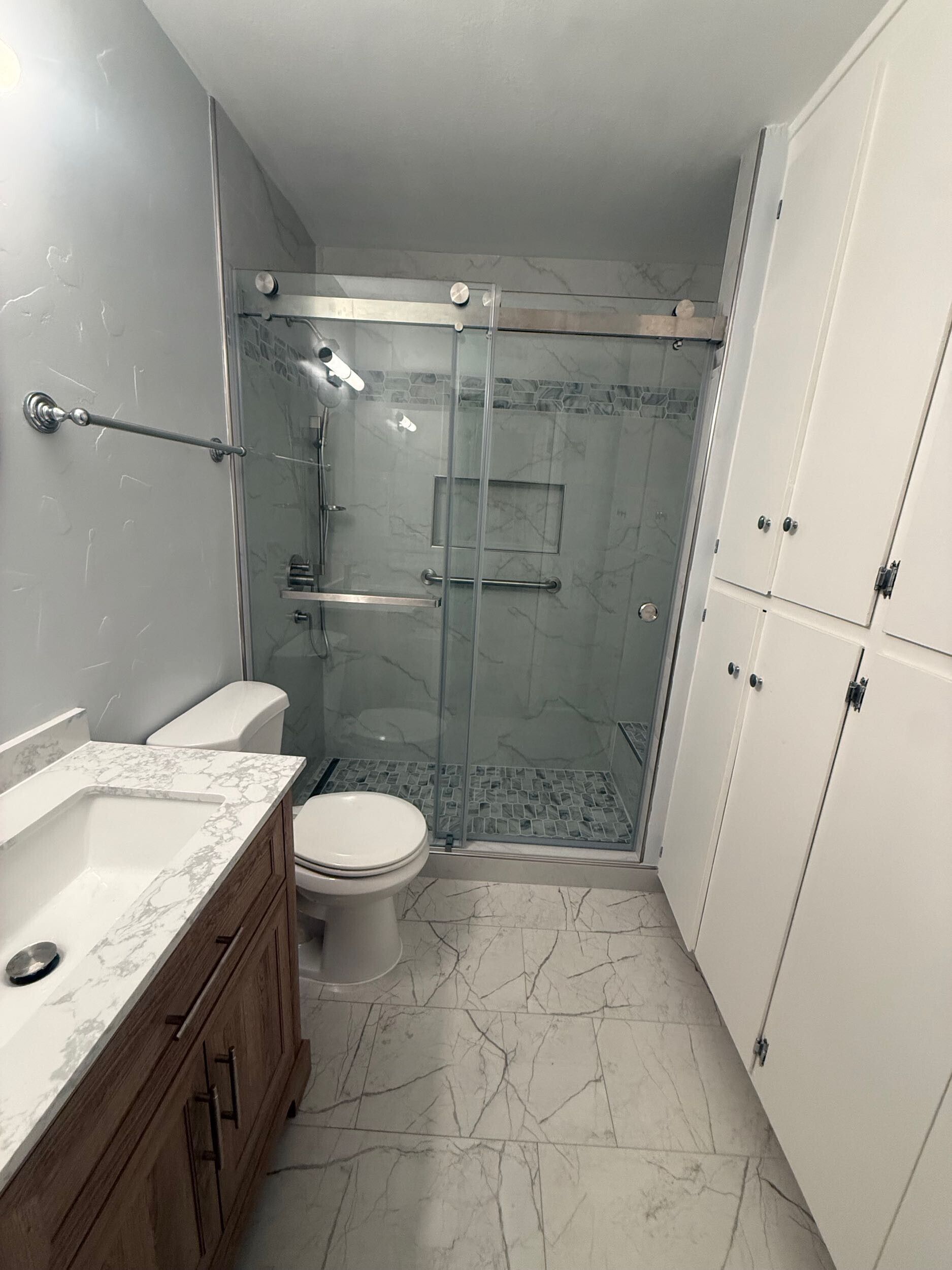 Dream Build Services delivered a full bathroom renovation in the Bay Area, upgrading an outdated bath into a sophisticated modern retreat. The project included new tile installation with marble patterns, a custom walk-in shower with glass doors and chrome fixtures, updated vanity cabinetry, and improved lighting for a brighter, more inviting space. This remodel combines functionality with elegant design, reflecting Dream Build Services’ commitment to quality craftsmanship and comfort.