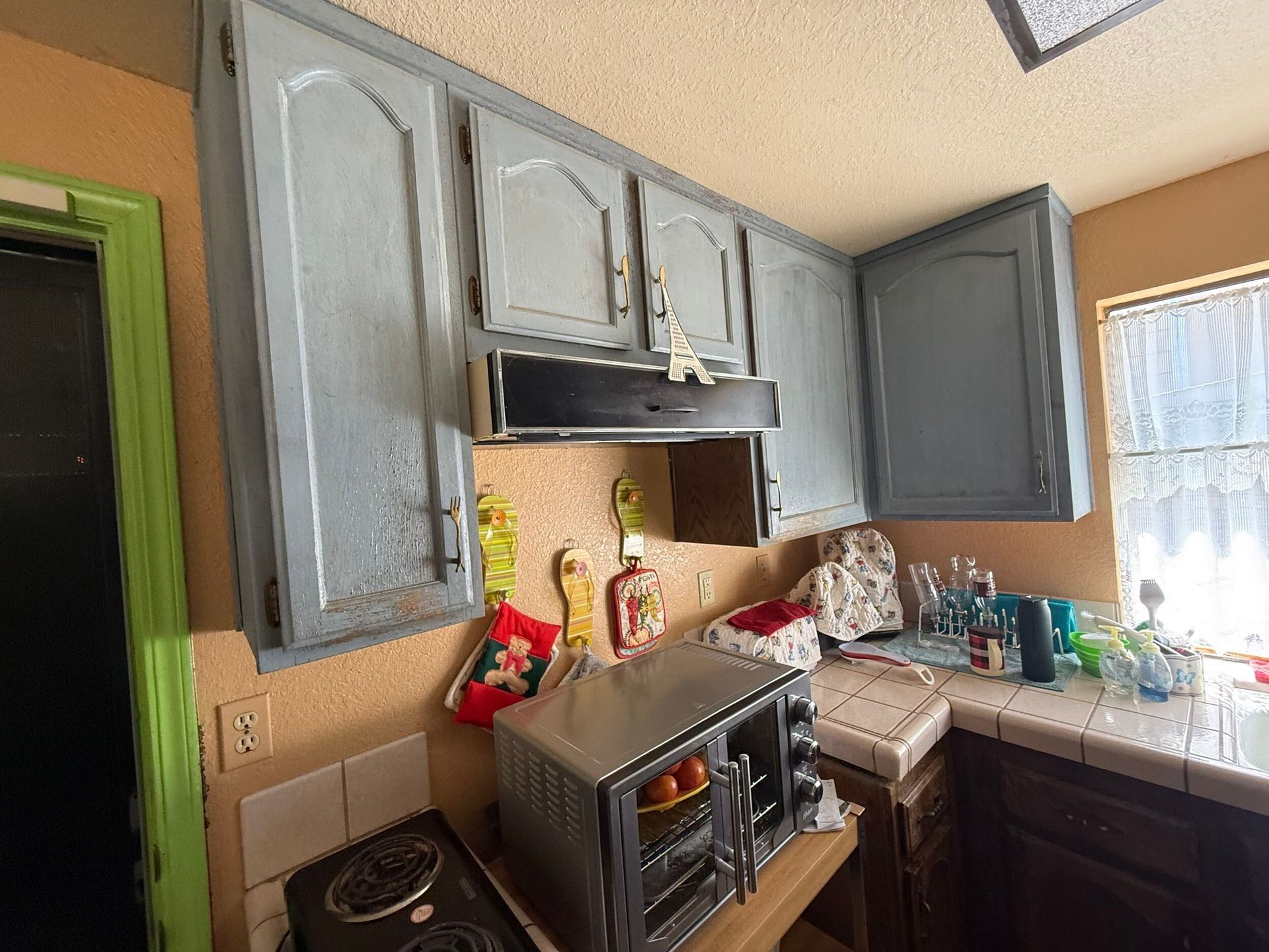 Modern kitchen remodel featuring new wood cabinetry, updated countertops, farmhouse sink, stainless steel appliances, and improved lighting. Full kitchen renovation showcasing before and after transformation, optimized layout, durable flooring, and contemporary finishes designed for functionality, comfort, and style in a residential home renovation project.