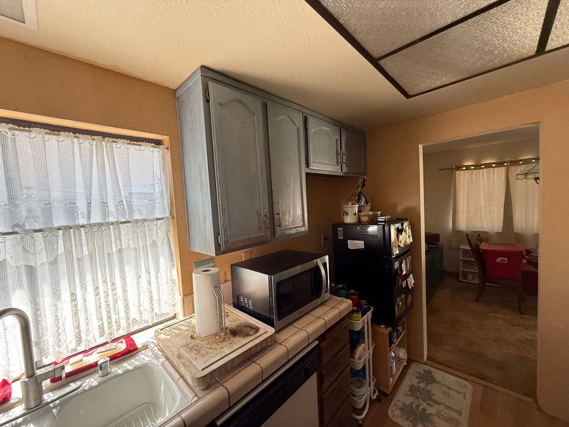 Modern kitchen remodel featuring new wood cabinetry, updated countertops, farmhouse sink, stainless steel appliances, and improved lighting. Full kitchen renovation showcasing before and after transformation, optimized layout, durable flooring, and contemporary finishes designed for functionality, comfort, and style in a residential home renovation project.