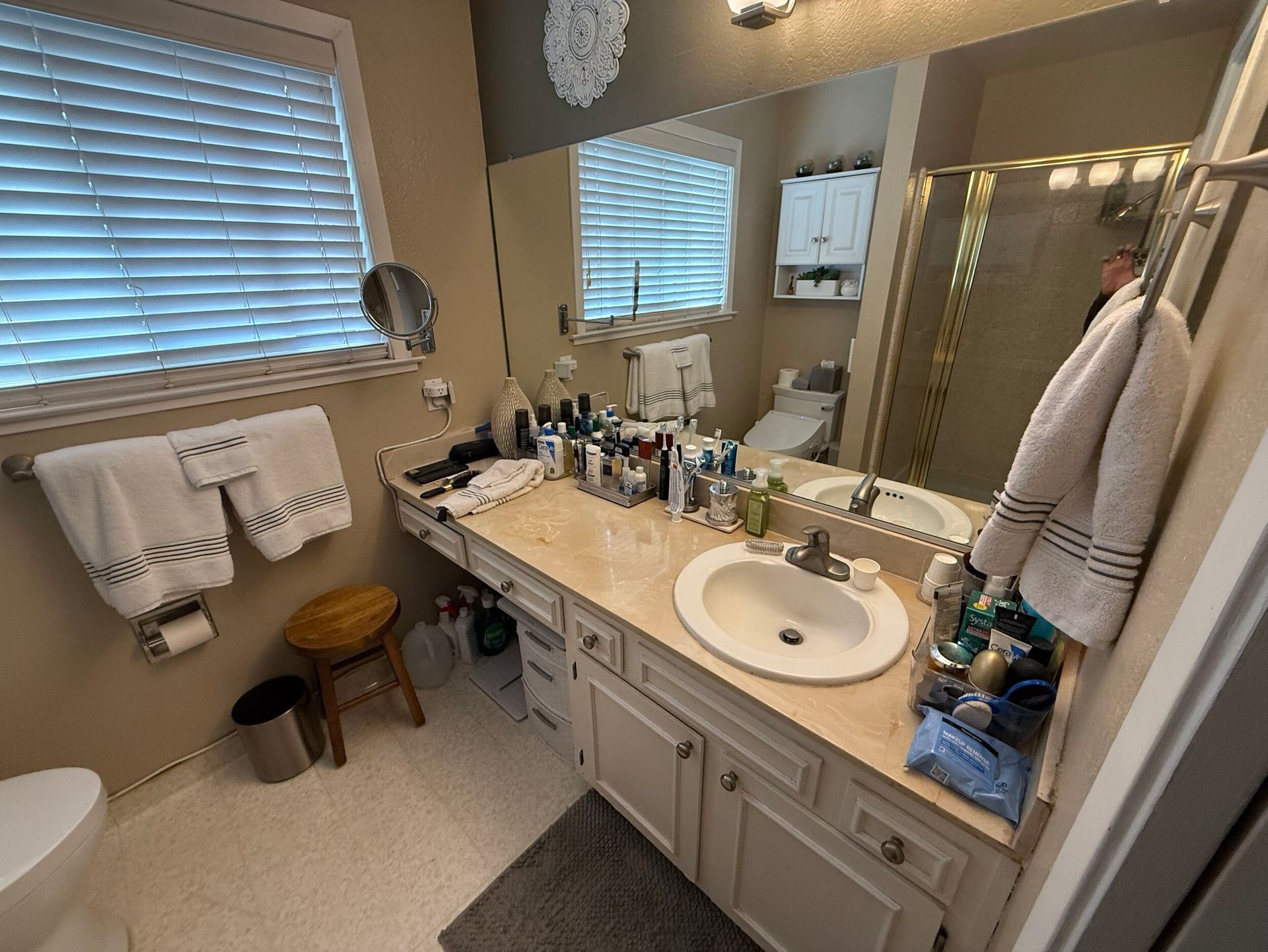 Updated bathroom remodel showcasing a modern walk-in shower with marble-style wall tile, pebble stone shower flooring, upgraded vanity with quartz countertop, contemporary sink and faucet, new lighting, and neutral color palette. Bathroom renovation completed by Dream Build Services, a residential remodeling contractor serving homeowners with bathroom and home renovation projects in the Bay Area.