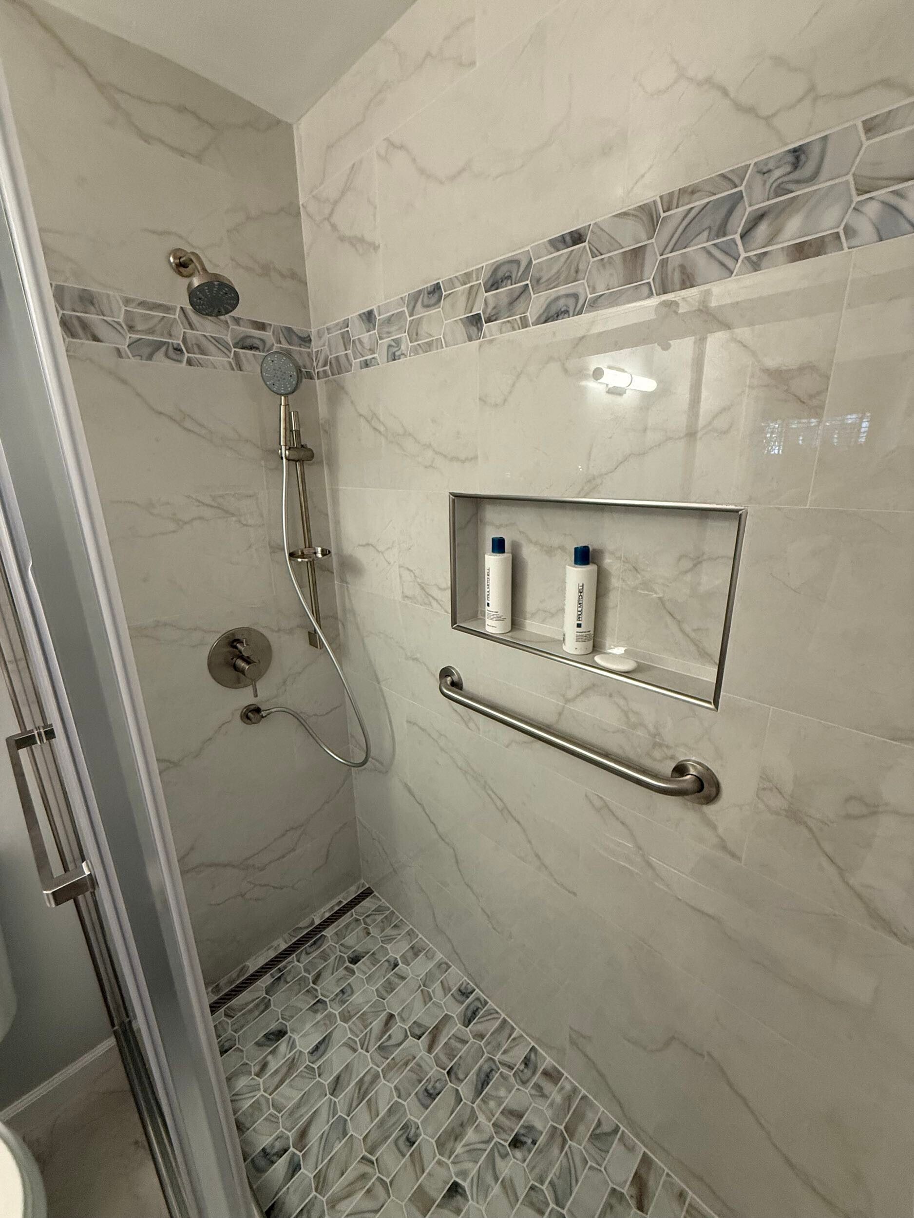 Dream Build Services delivered a full bathroom renovation in the Bay Area, upgrading an outdated bath into a sophisticated modern retreat. The project included new tile installation with marble patterns, a custom walk-in shower with glass doors and chrome fixtures, updated vanity cabinetry, and improved lighting for a brighter, more inviting space. This remodel combines functionality with elegant design, reflecting Dream Build Services’ commitment to quality craftsmanship and comfort.