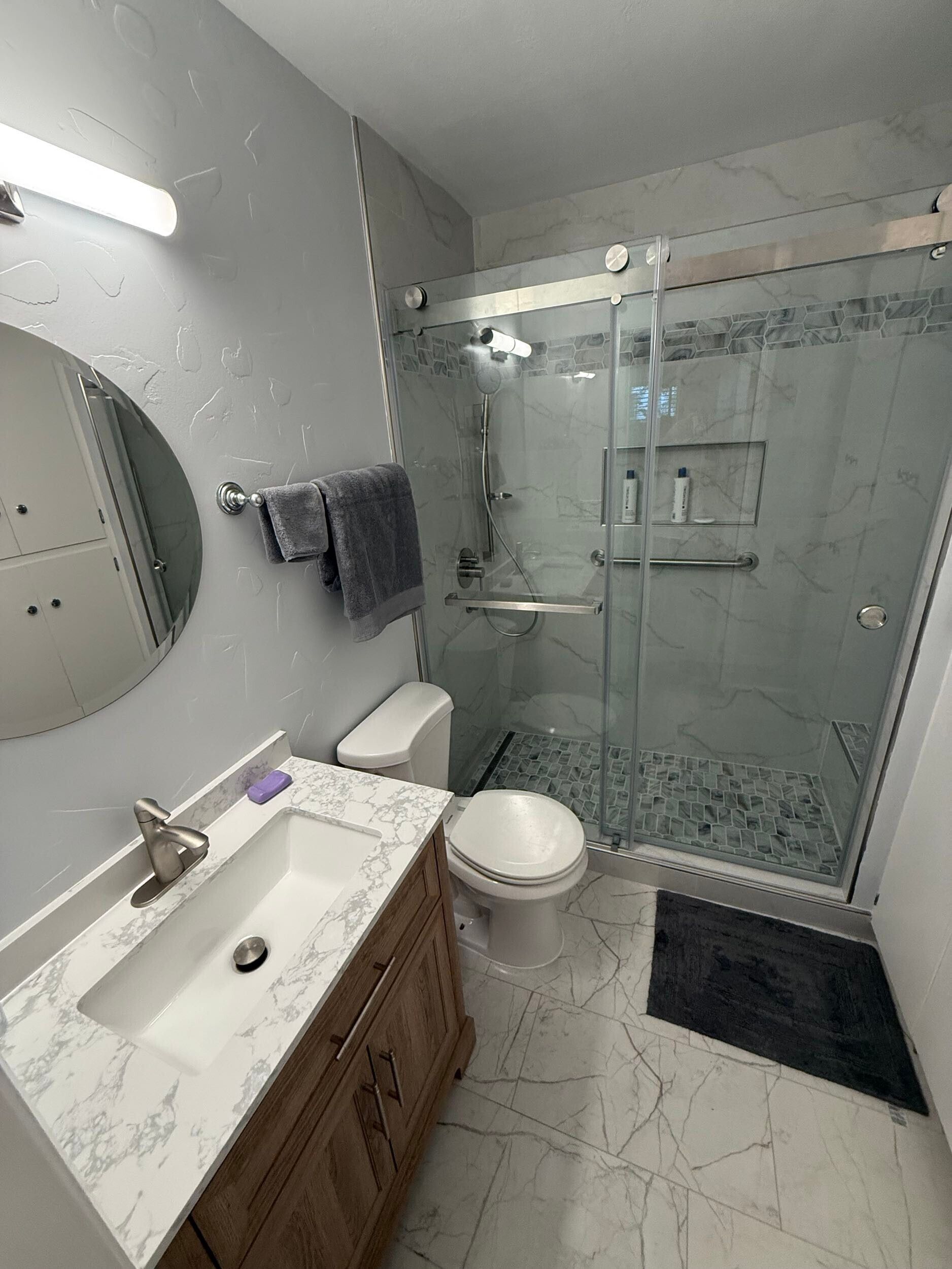 Dream Build Services recently completed an accessible bathroom renovation in the Bay Area, transforming an outdated and narrow layout into a modern, mobility-friendly space. The remodel features a spacious walk-in shower with grab bars, a built-in bench, modern lighting, and sleek tile design. Ideal for aging-in-place, senior accessibility, and improved home safety.