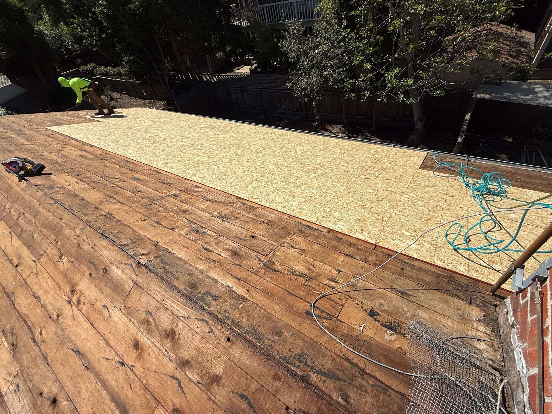 A wooden deck with a lot of gravel on it.