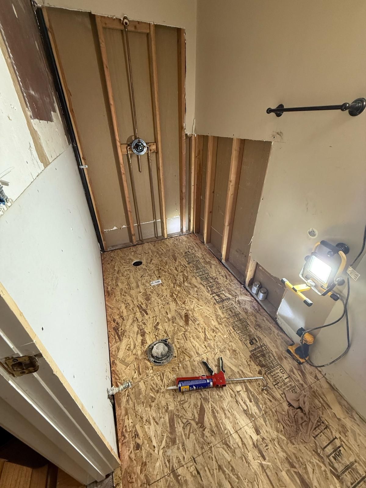 A bathroom under construction with a wooden floor.