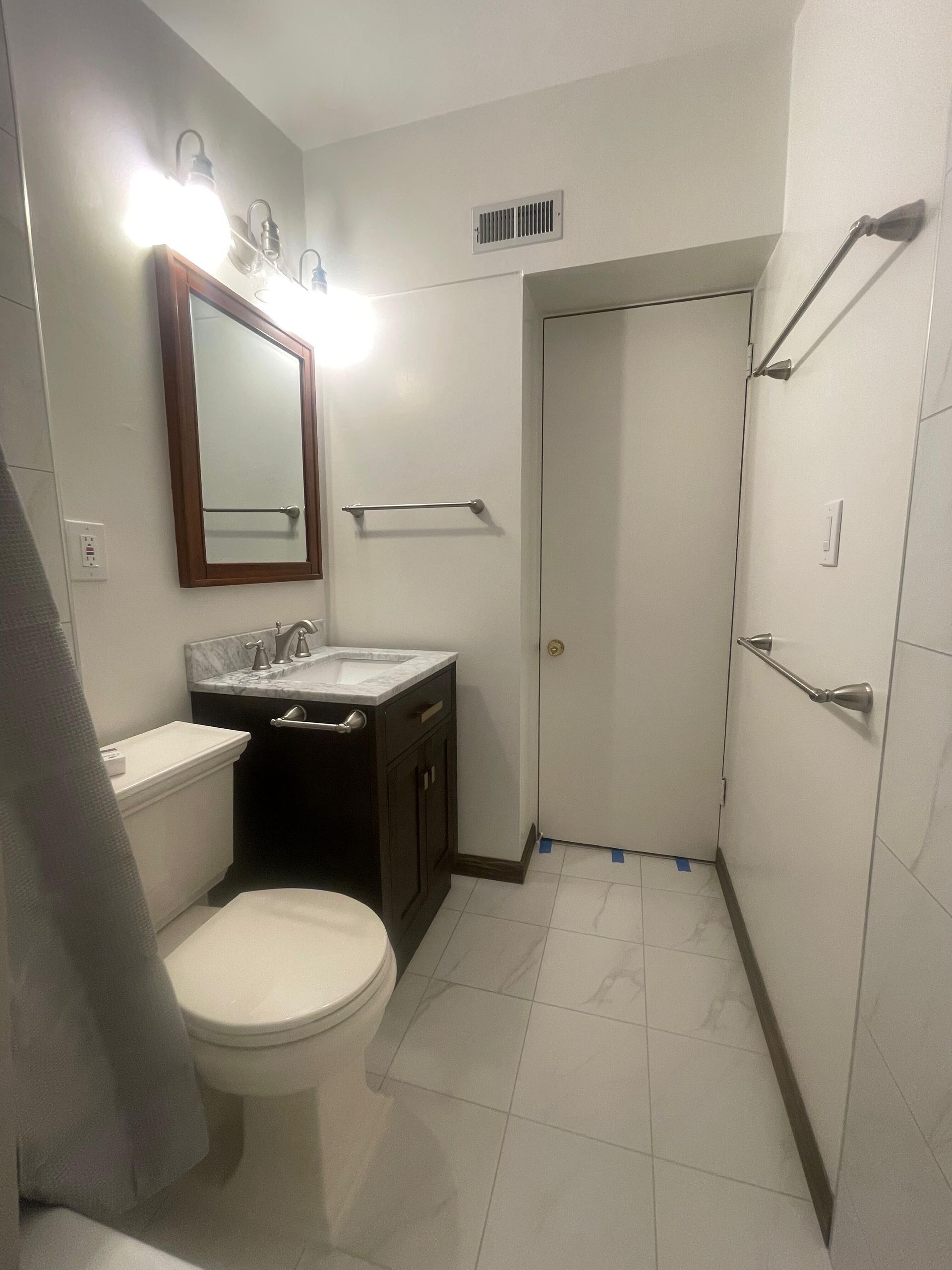 This bathroom remodel by Dream Build Services showcases a complete transformation from an outdated design to a modern, elegant space. The renovation included new marble-look wall and floor tiles, a sleek vanity with upgraded hardware, energy-efficient lighting, and modern plumbing fixtures. The result is a brighter, cleaner, and more functional bathroom that blends comfort and contemporary style. Located in the Bay Area, Dream Build Services specializes in bathroom remodels, home renovations, and functional design improvements.