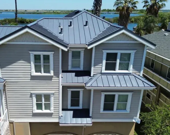 An aerial view of a house with a metal roof