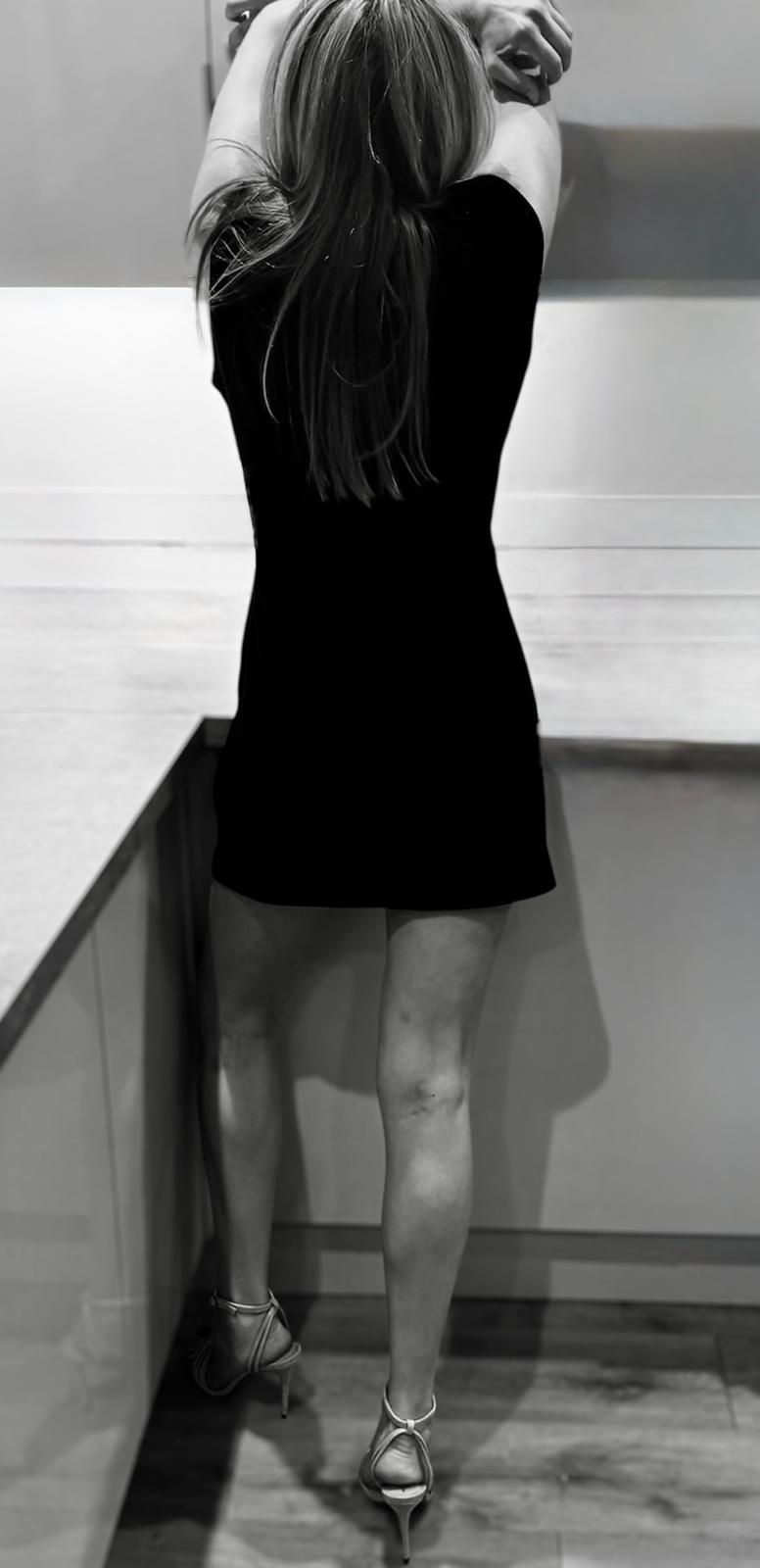 Lara in short dress with long legs. Couple escort Manchester, Liverpool and Cheshire.
