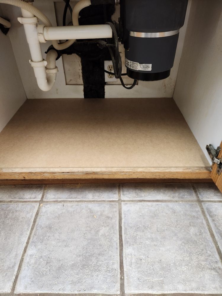 A kitchen sink with a garbage disposal underneath it.