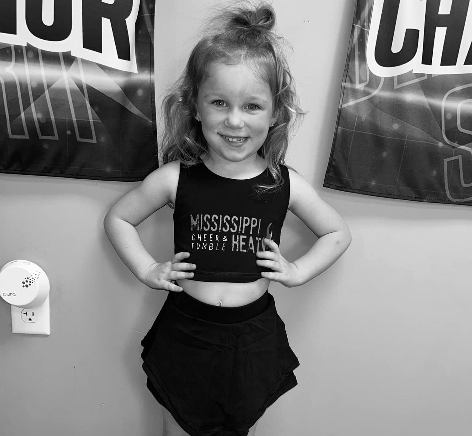 A little girl wearing a black mississippi shirt