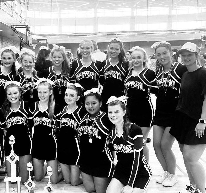 A black and white photo of cheerleaders posing for a picture