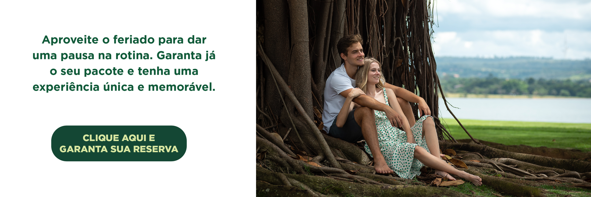Casal sentado sob uma árvore, olhando para um lago. Texto em português promove um feriado.