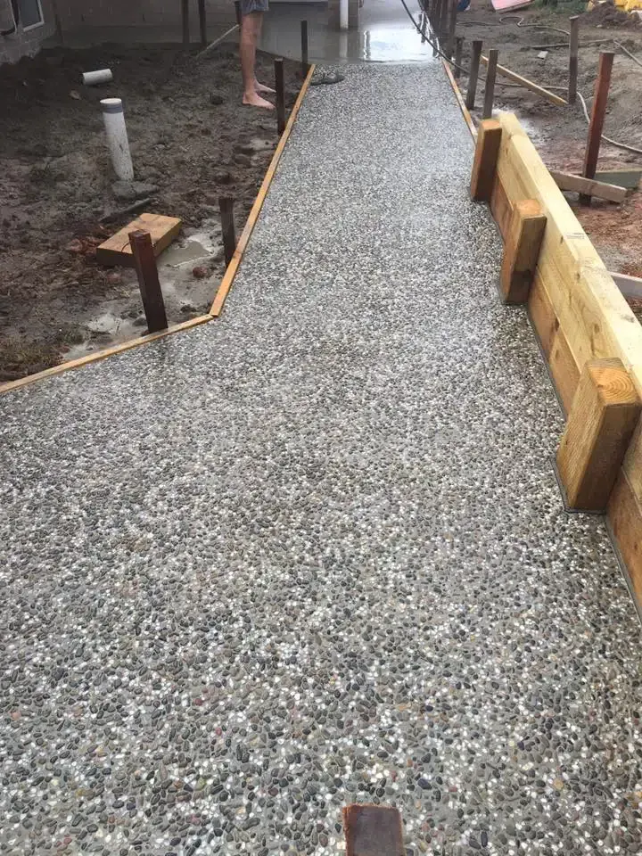 A Concrete Walkway With A Wooden Border Is Being Built — Luke Seears Concreting in Port Macquarie, NSW