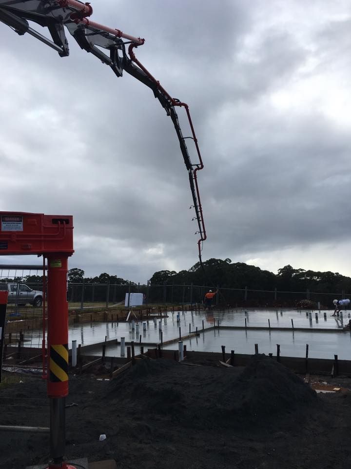 A Concrete Pump Is Being Used To Pour Concrete Into A Pool — Luke Seears Concreting in Lake Cathie, NSW