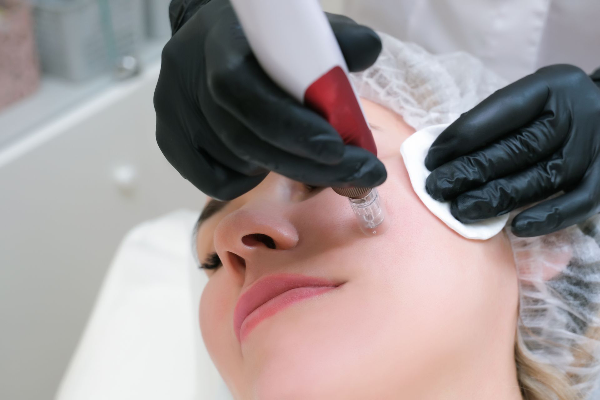 A woman is getting a facial treatment at a beauty salon.