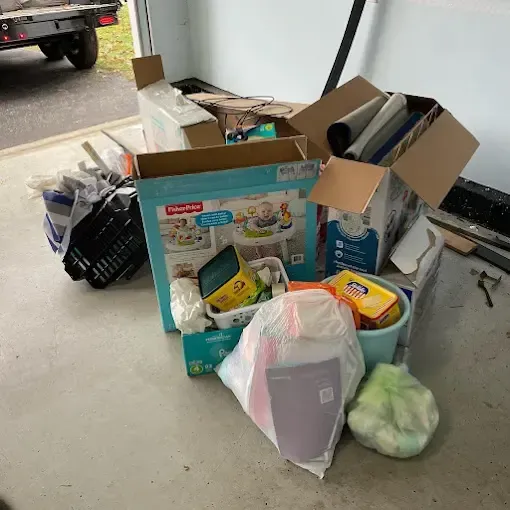 A bunch of boxes are sitting on the floor in a garage.