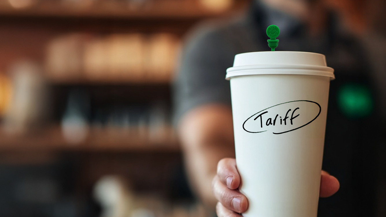 Barista holding coffee cup labeled 