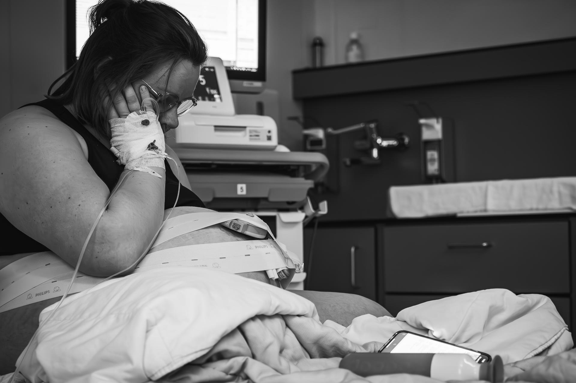 Een zwart-witfoto van een vrouw in een ziekenhuisbed