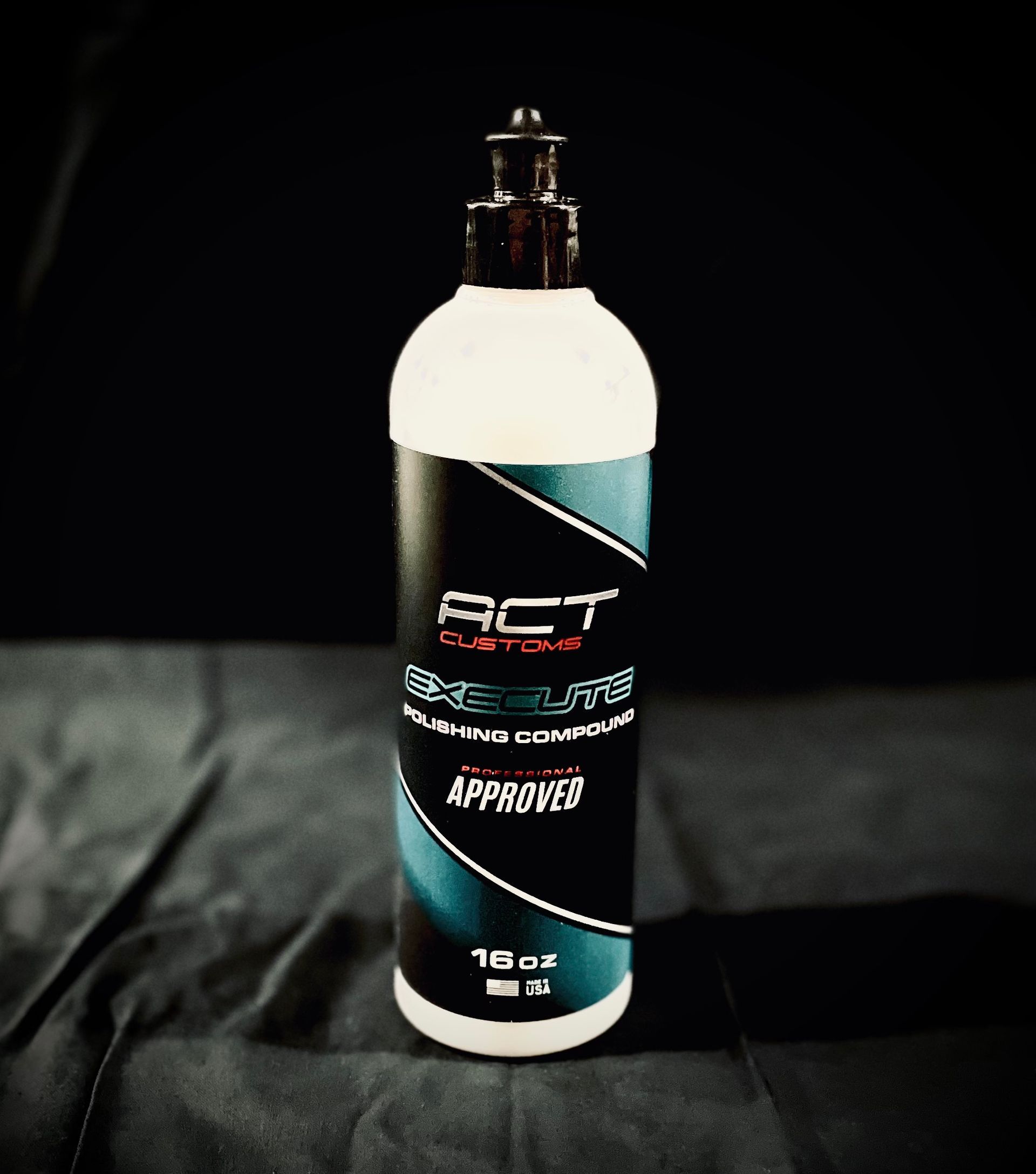 A bottle of act polish sits on a black cloth