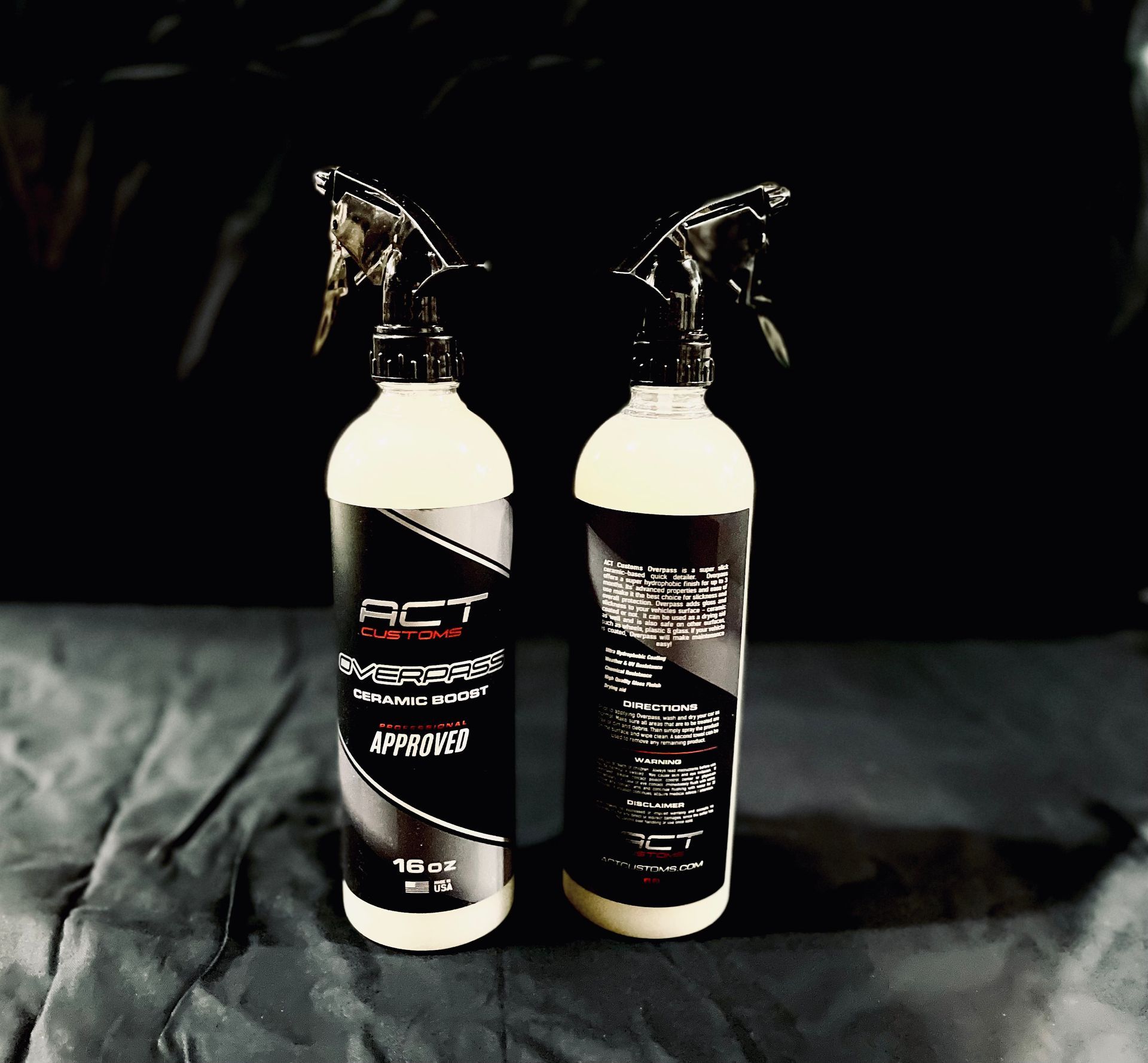 Two bottles of act spray sitting on a table