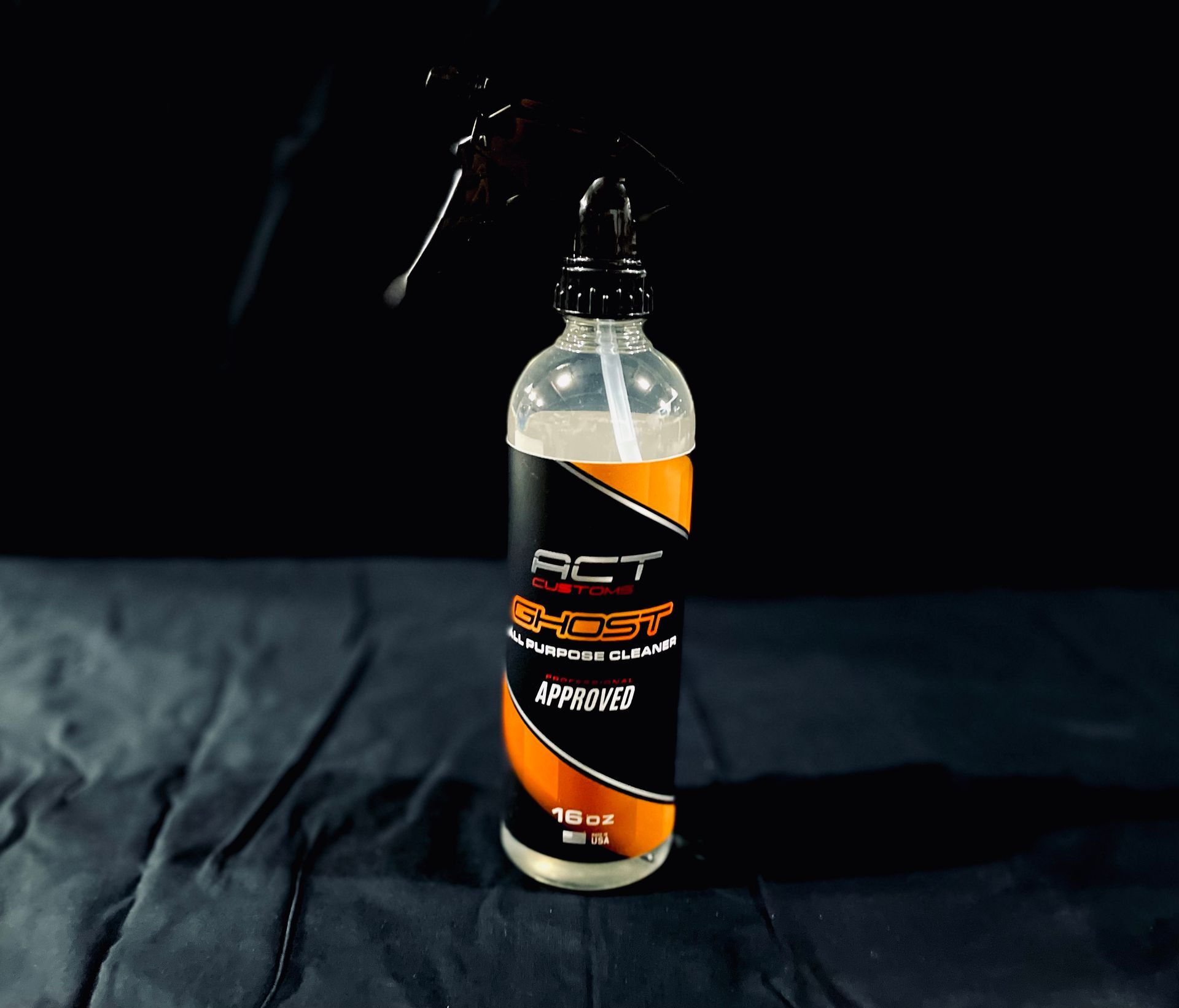 A bottle of act k-boost spray sitting on a table.