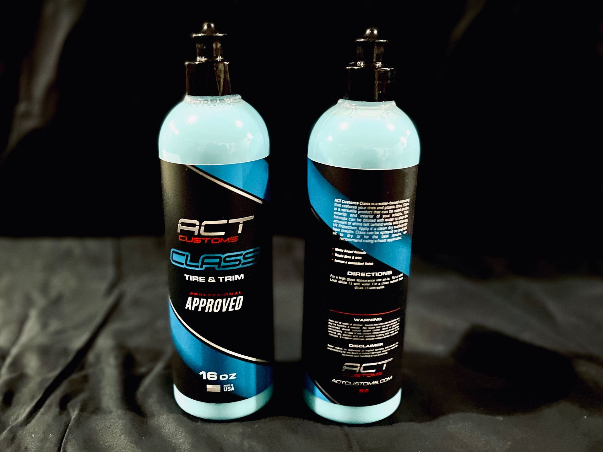 Two bottles of act car polish are sitting next to each other