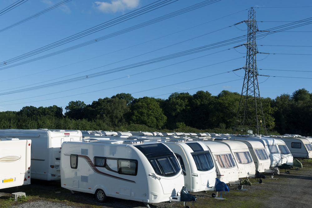 A row of caravans are parked next to each other in a parking lot — Toowoomba Lube & Mechanical in Glenvale, QLD