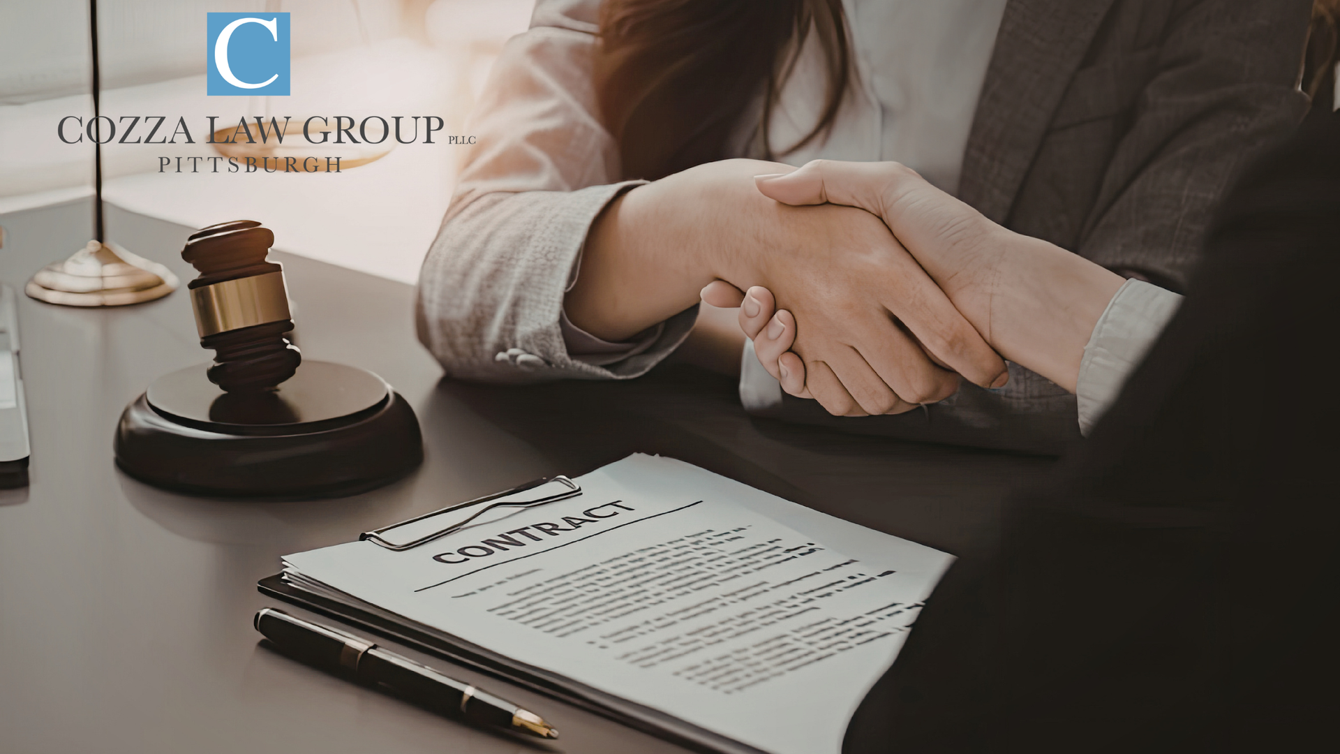 Two people shaking hands over a contract