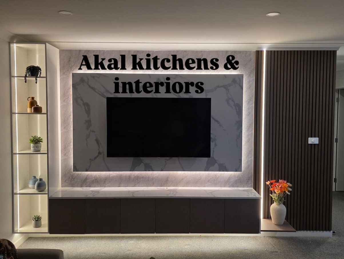 Modern entertainment unit with marble accent wall, TV, cabinetry, and shelving with LED lighting.