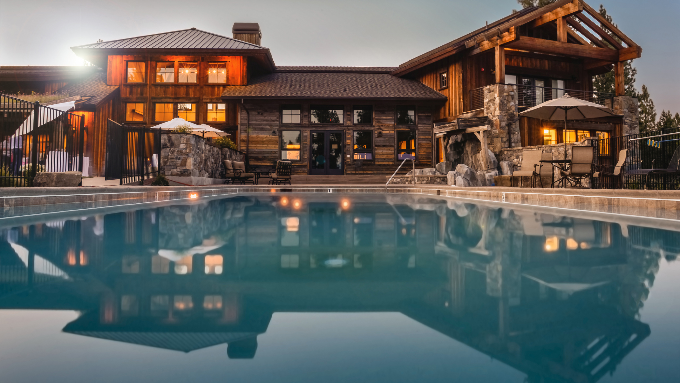 A luxurious modern home in Washington State with large glass windows, a well-manicured lawn