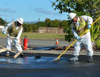 pavement cracking — worker of Q-Stripe for road sealing in Evansville, IN