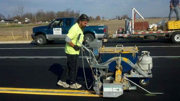 Henderson County — Man sealing pavements in Evansville, IN