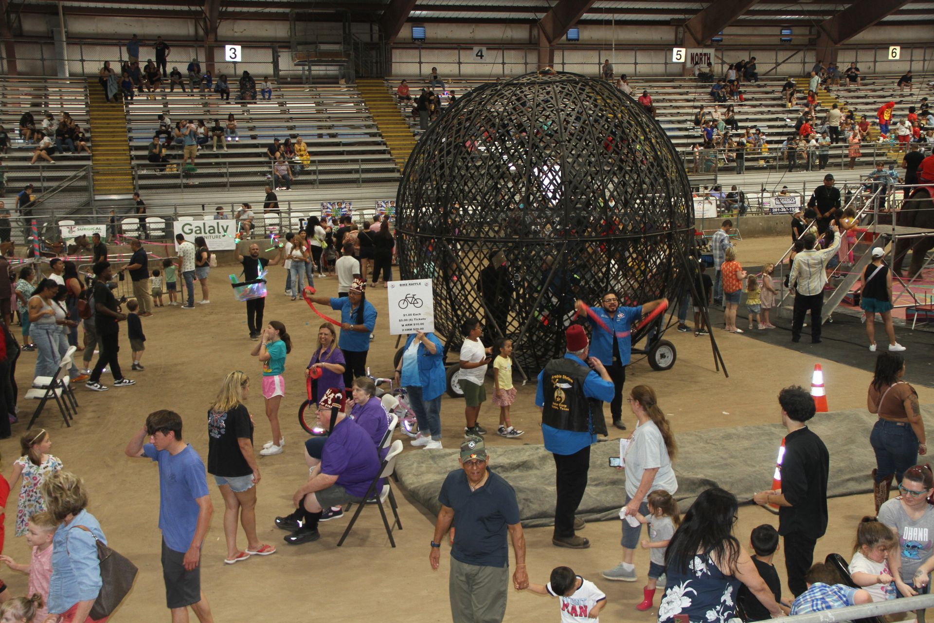 A large group of people are gathered in a large stadium | Arabia Shrine Circus