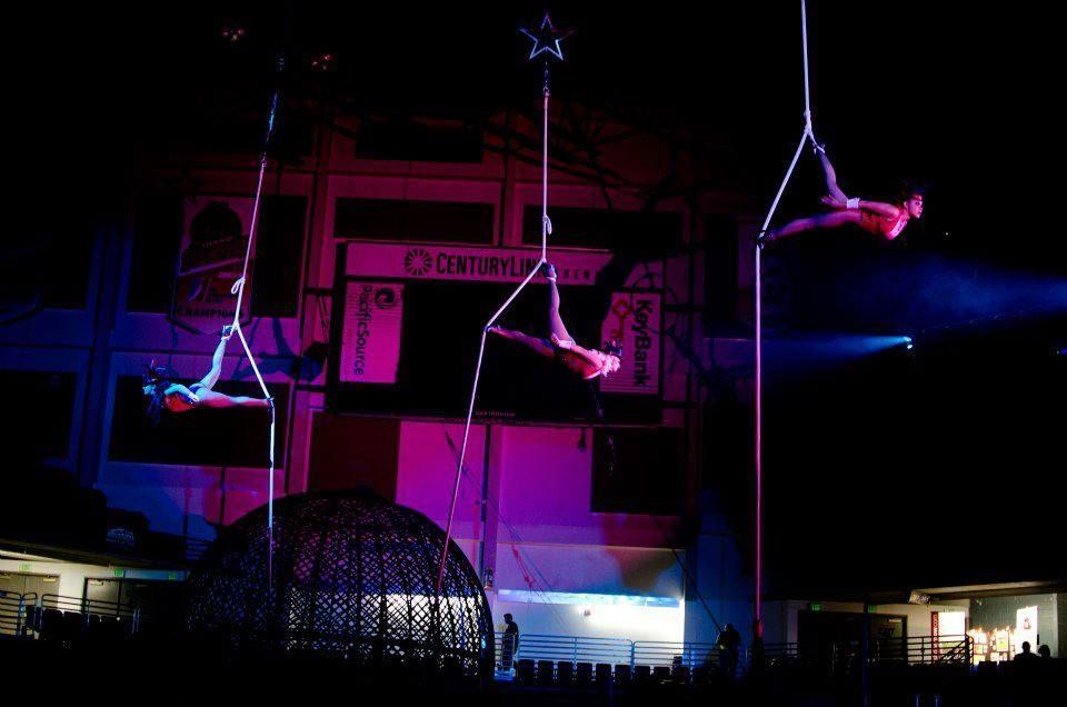 A group of people are performing aerial acrobatics | Arabia Shrine Circus