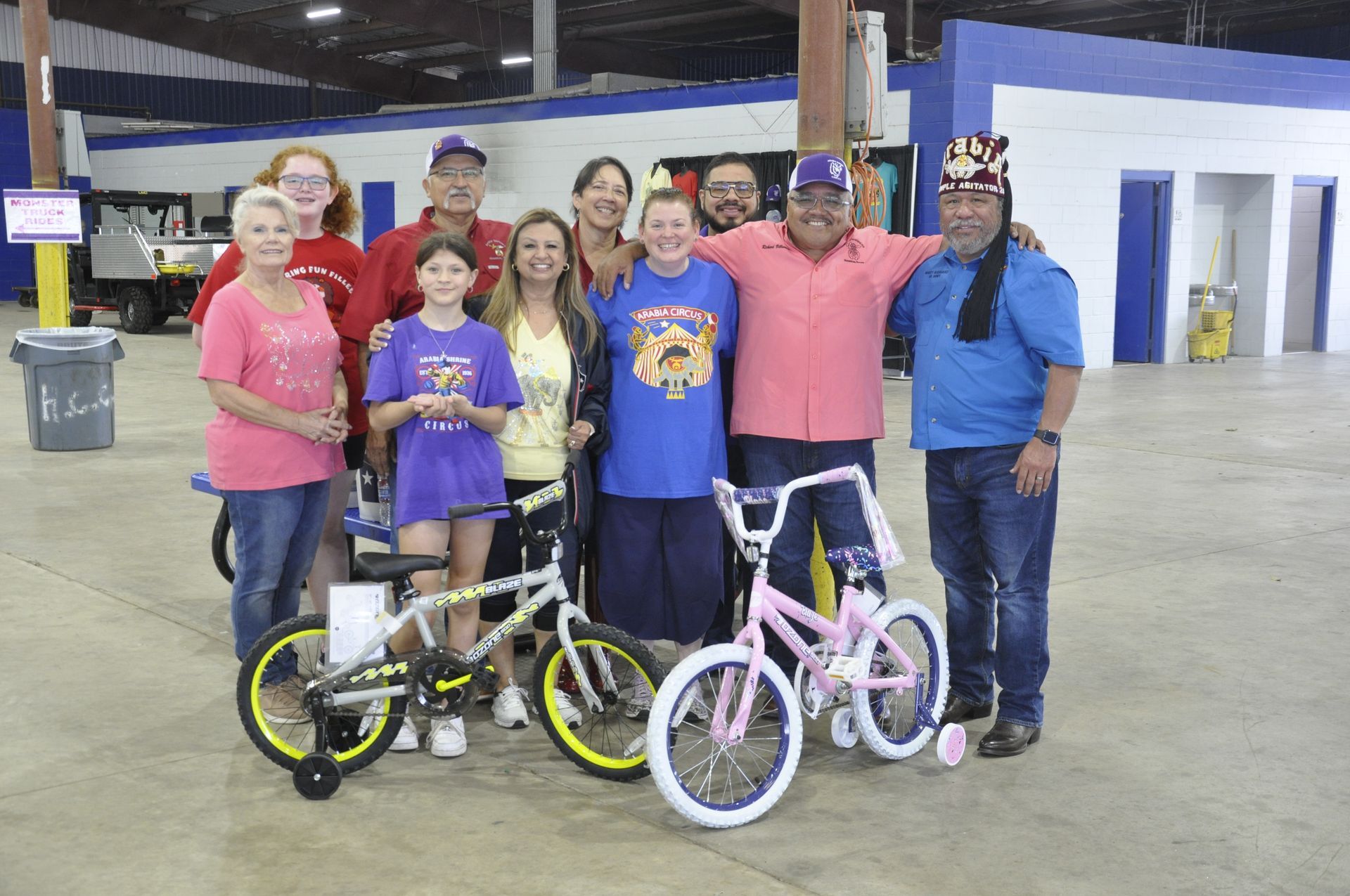 A group of people posing for a picture with bicycles | Arabia Shrine Circus
